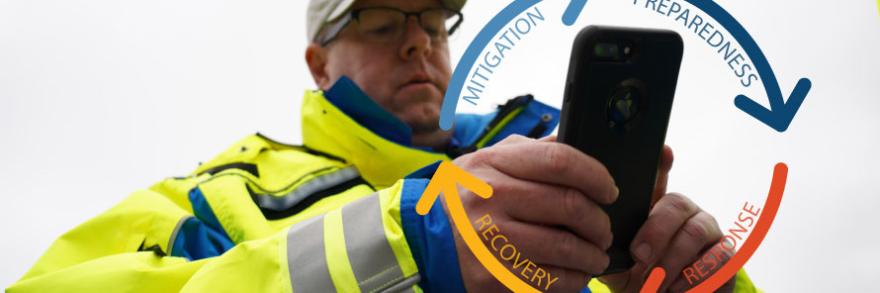 First responder holding a smartphone. Symbol of emergency management cycle. 