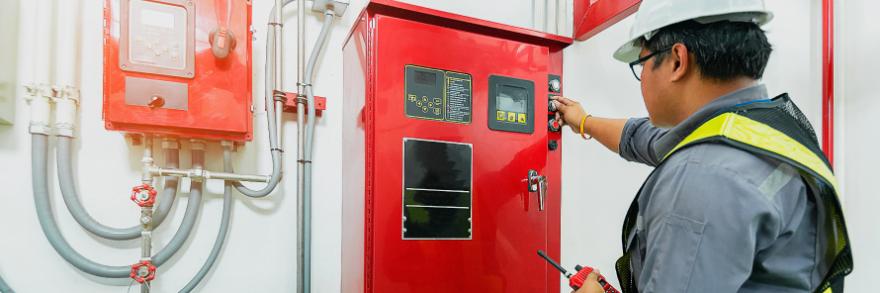 A worker inspects a fire unit