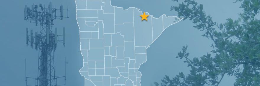 The state of Minnesota, with outlined county borders and a star locating the Kabetogama State Forest; a cell tower and tree