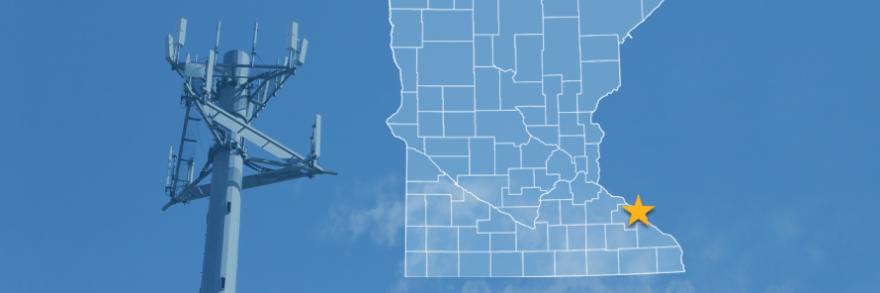 The state of Minnesota, with outlined county borders and a star locating the city of Kellogg; a cell tower