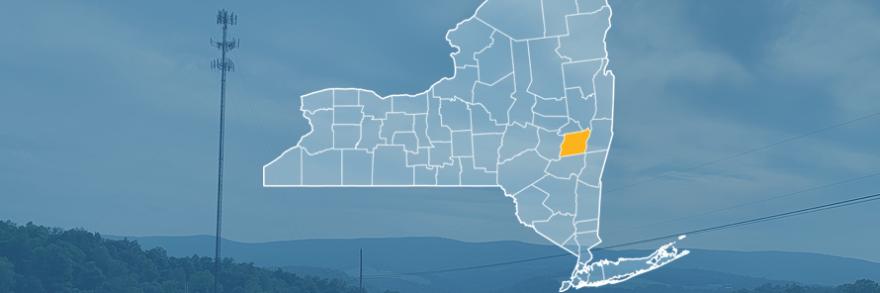 The state of New York, with outlined county borders; a cell tower.