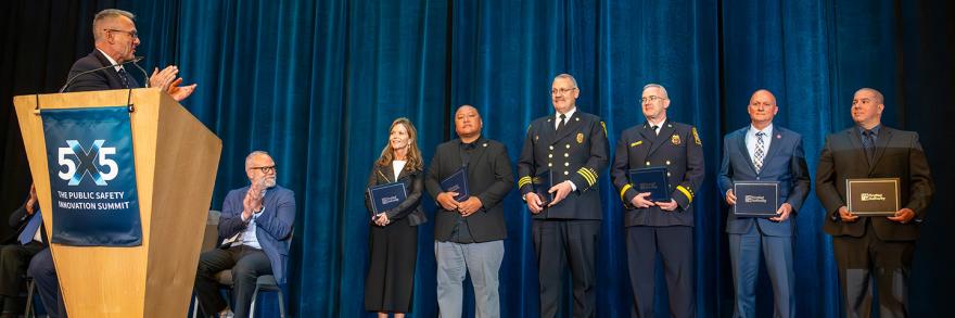 Six 2025 Patriot Award winners stand on stage after receiving their award
