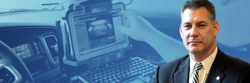 Peter Koutoujian headshot; a police officer using a laptop in the front seat of a cruiser