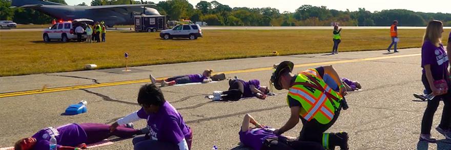During a large-scale incident at an airport, first responders are attending crash victims on runway.