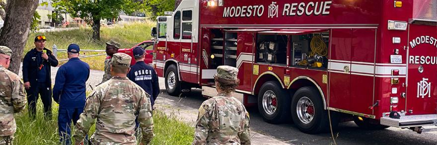 A group of Sacramento Fire Department firefighters standing in front of a fire engine