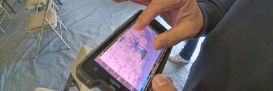 An officers holds a FirstNet device used to track severe weather events and share real time data with responders.