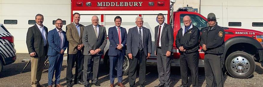 Local leaders and FirstNet Authority staff stand in front of a Middleburg ambulance