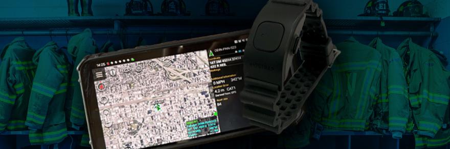 Smartphone displaying mapping location; wrist wearable device; background of firefighter uniforms hanging in a row. 