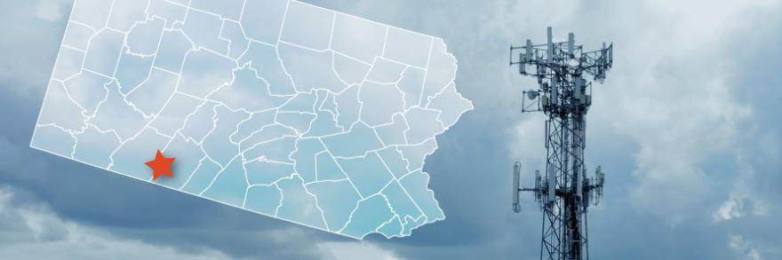 The state of Pennsylvania, with outlined county borders; star marking Hyndman in Bedford County; a FirstNet cell tower