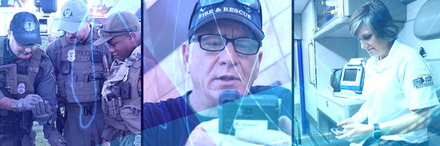 Three police officers consult information on a smartphone, a firefighter looks at a rugged device, an EMS technician next to a patient gurney in the back of an ambulance looks down at a smart device