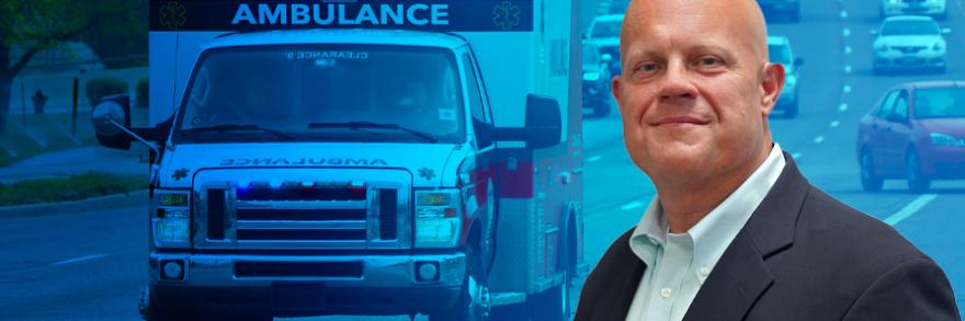 An ambulance driving down a busy highway; Jon Olson headshot