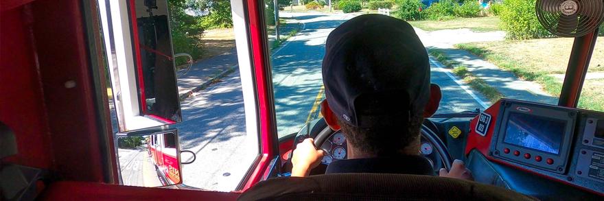 View of a town street from the windshield of a fire apparatus as a firefighter from the Hyannis Fire Department drives