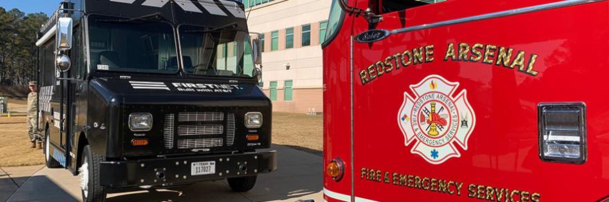 A Redstone Arsenal fire truck faces a FirstNet Emergency Mobile Communications Vehicle