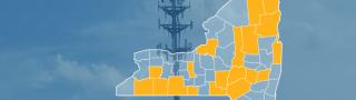 The state of New York, with outlined county borders; a cell tower.