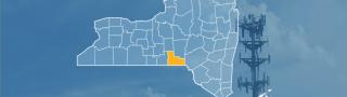 The State of New York, with outlined county borders; a cell tower.