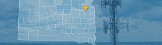 The state of South Dakota, with outlined county borders and star locating cell site; a cell tower.