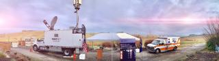 FirstNet Satellite Cell on Wheels, tent with FirstNet banner, and ambulance standing on road in Yamhill County, Oregon 