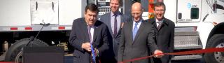 Congressman C.A. Dutch Ruppersberger cuts a red ribbon as FirstNet Authority Acting CEO Ed Parkinson looks on in front of an AT&T Satellite Cell on Light Truck