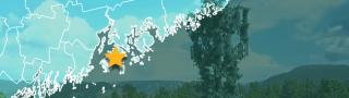 County map of Maine, star over Stonington, cell tower against mountains