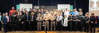 Texas first responders and hospital personnel and AT&T representatives stand in a group.