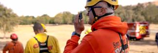 Santa Clara responder speaks into a smartphone while in the field