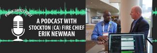 Chief Erik Newman and Dave Buchanan stand at a table together