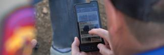 A police officer choosing an image to send on his FirstNet enabled smartphone