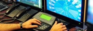 Security officer monitoring casino floor through security cameras