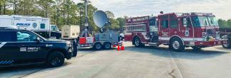 A FirstNet Compact Rapid Deployable and FirstNet, Fire & Rescue, and Police vehicles parked at Military Ocean Terminal Sunny Point, North Carolina