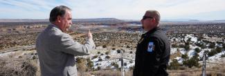 A public safety officer and a FirstNet Authority staff member speak with each other overlooking a Navajo reservation