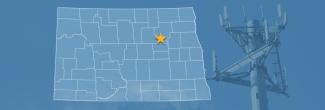 The state of North Dakota, with outlined county borders and a star locating Spirit Lake Reservation, North Dakota; a cell tower.