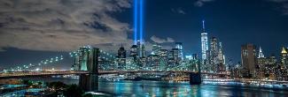 New York City skyline with two beams of light in the sky marking September 11 remembrance 