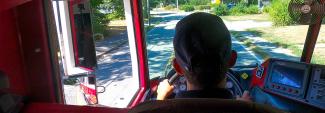 View of a town street from the windshield of a fire apparatus as a firefighter from the Hyannis Fire Department drives