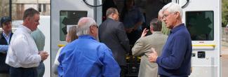 Tip Osterthaler speaks with public safety officials in front of ambulance