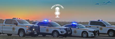 Public Safety First Podcast logo; "FirstNet is 'Force Multiplier' for Nebraska Sheriff's Office;" Buffalo County Sheriff's Office trucks, SUV, and cruiser parked on road next to a field; a sunset