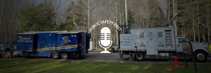 Michigan State Police mobile command vehicle parked next to FirstNet Satellite Cell on Light Truck in wooded area; Public Safety First podcast icon