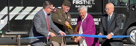 Deputy Commanding General of Army Materiel Command Lieutenant General Donnie Walker cuts a ribbon held by FirstNet Authority Board member Chief Richard Carrizzo, Alabama Governor Kay Ivey, and AT&amp;T Alabama President Wayne Hutchens in front of a FirstNet Emergency Mobile Communications truck.