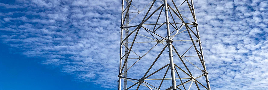 Cell tower with sky in background